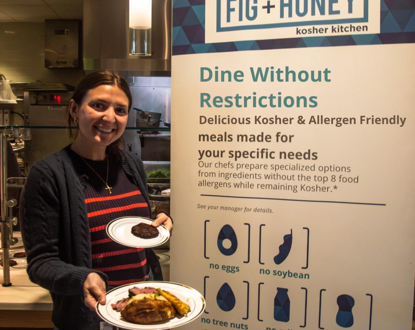 A woman holds a dish from UHart Dining's Kosher True Balance station.